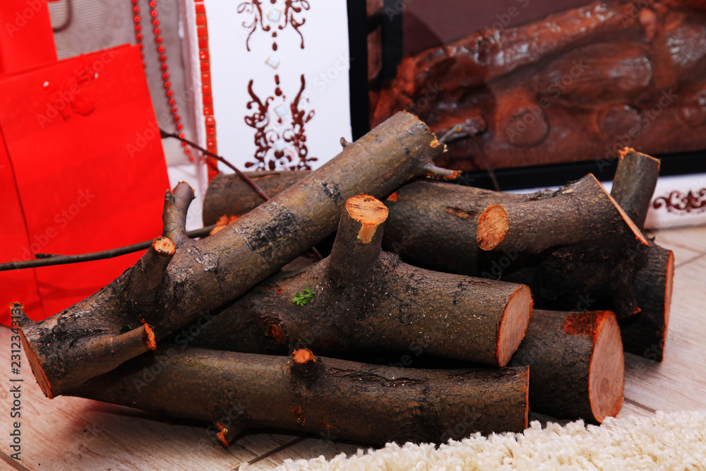warm cozy home environment for New year celebration with decorations, Christmas tree, garlands by the burning fireplace with wine glass warm cozy home environment for New year celebration with decorations, Christmas tree, garlands by the burning fireplace with wine glass