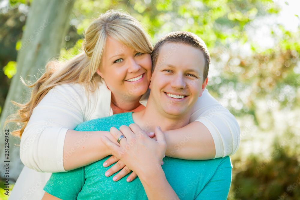 Young Attractive Couple Hugging in the Park Young Attractive Couple Hugging in the Park