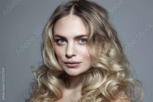 Young beautiful blonde woman with long curly hair