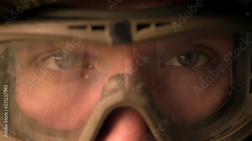Close-up eyes of caucasian soldier on helmet and camouflage looking straight at camera, calmly, persistent look, power illustration