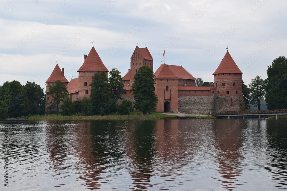 Trakai island castle at the lake. Reflection in water.
