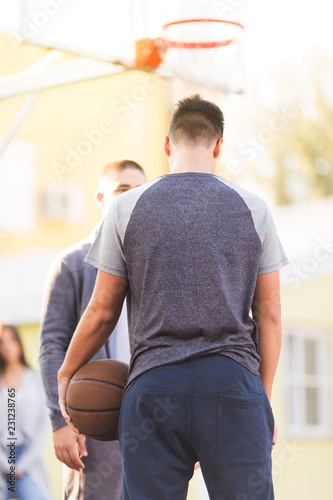 Teenage boys playing basketball