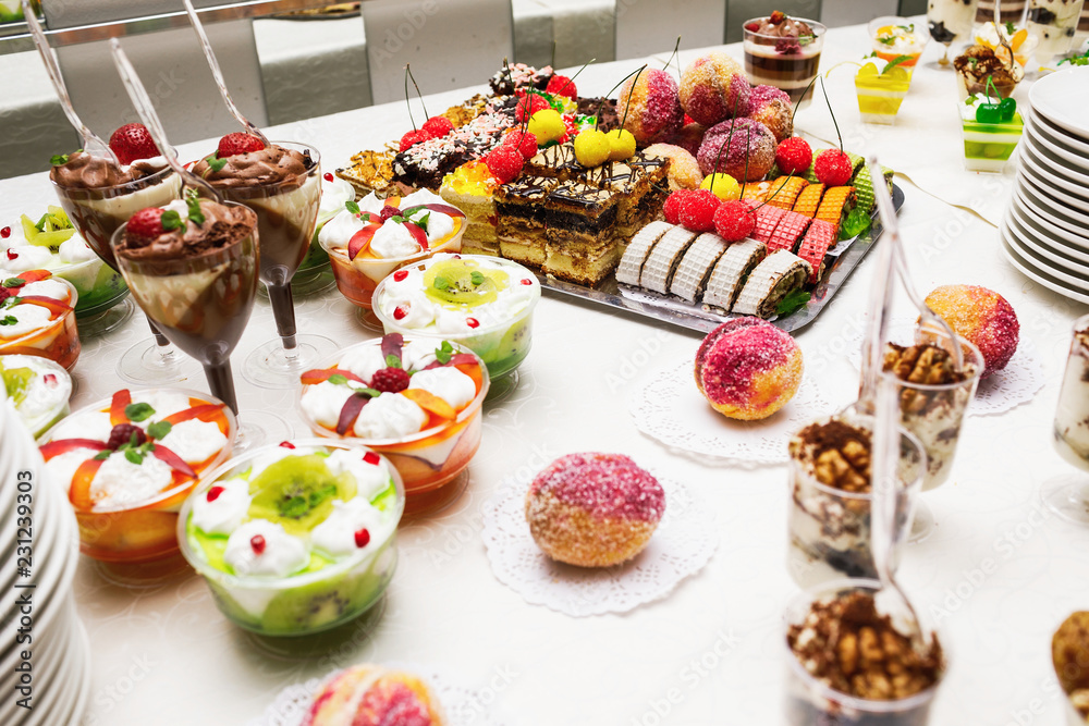 Modern desserts, cupcakes, sweets with fruits. Delicious candy bar. Catering Concept.