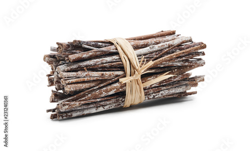 Side view of dry twigs tied in a bundle with natural twine isolated on a white background.