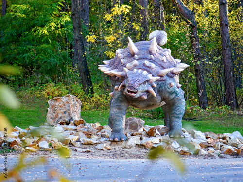 Big model of prehistoric dinosaur in nature. Realistic scenery. photo