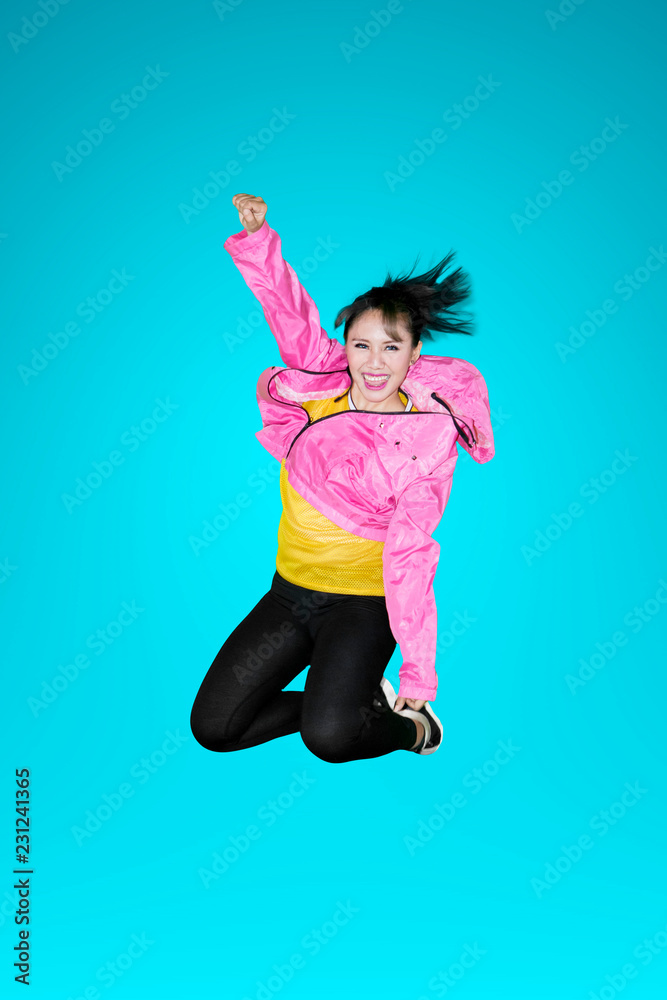 Joyful modern style dancer jumping in studio