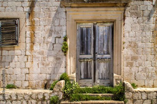 old wooden door in stone wall