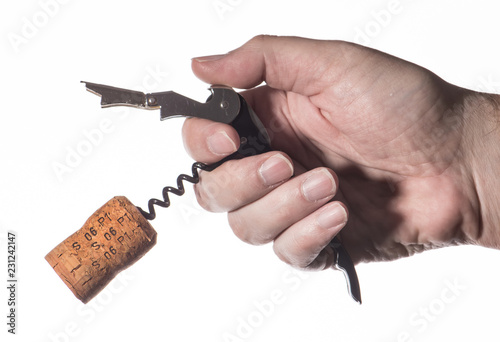 Male hand opens a bottle of wine. Cork and corkscrew.