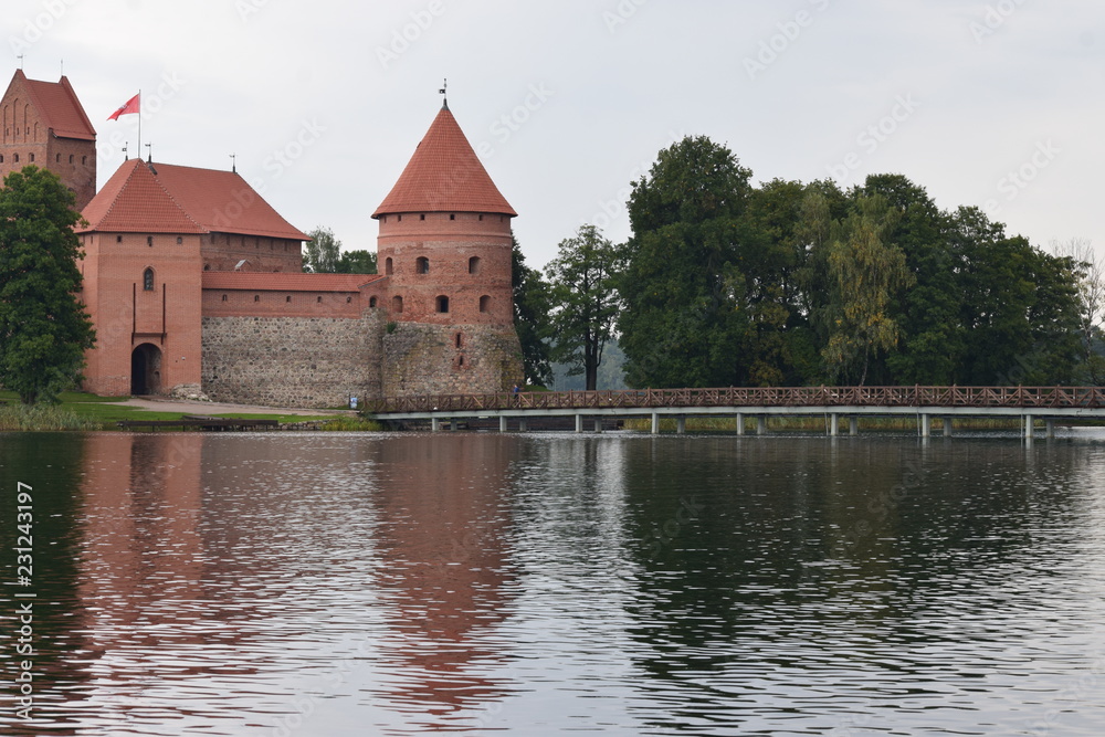 Trakai island castle at the lake. Reflection in water.