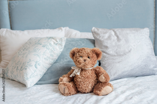 New Year's and Christmas! A teddy bear is waiting for his child on a bed in a decorated festive Christmas room. Christmas children's bedroom