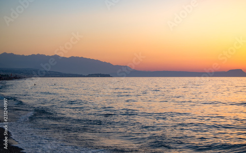Fototapeta Naklejka Na Ścianę i Meble -  Sunset in the beach of Aegeian sea in Adelianos Kampos resort, Crete island, Greece