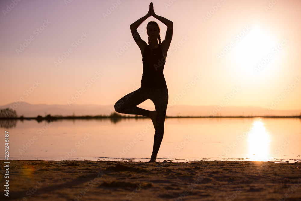 girl doing yoga at sunset
