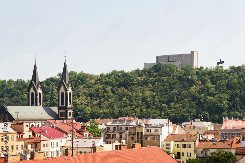 Prague panorama with Jan Zizka equestrian statue in front of National memorial Vitkov, Karlin district with Church of Saints Cyril and Methodius in foreground, sunny summer day, Czech Republic