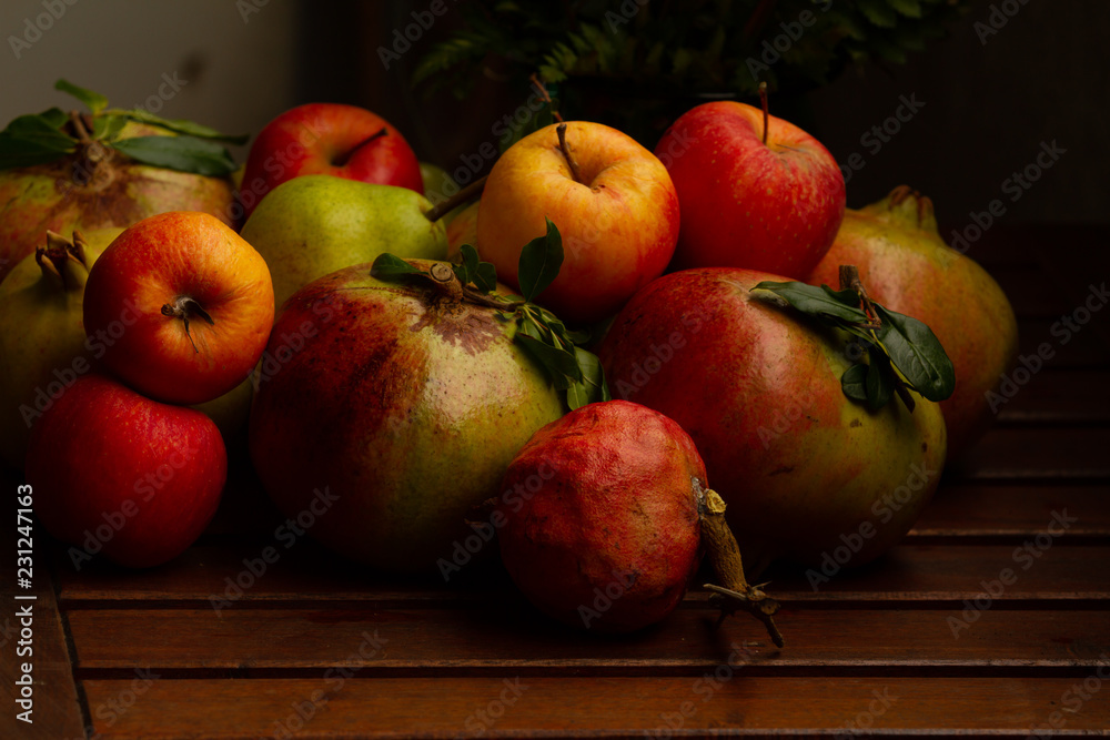 Composition of Autumn fruits (pomegranates, apples, pears)