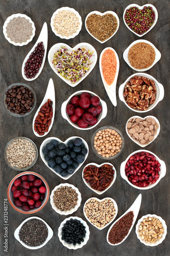 Vegan and vegetarian dried and fresh health food with fruit  vegetables  cereals  nuts  seeds  coffee  grains and herbs with super foods high in antioxidants  anthocyanins  dietary fibre and vitamins.