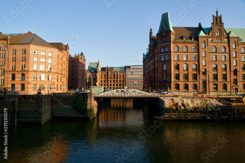 Red houses of the Speicherstadt mirroring in the water