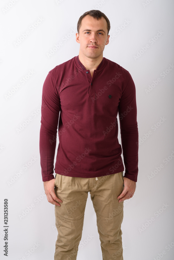Fototapeta premium Studio shot of young muscular man standing against white backgro