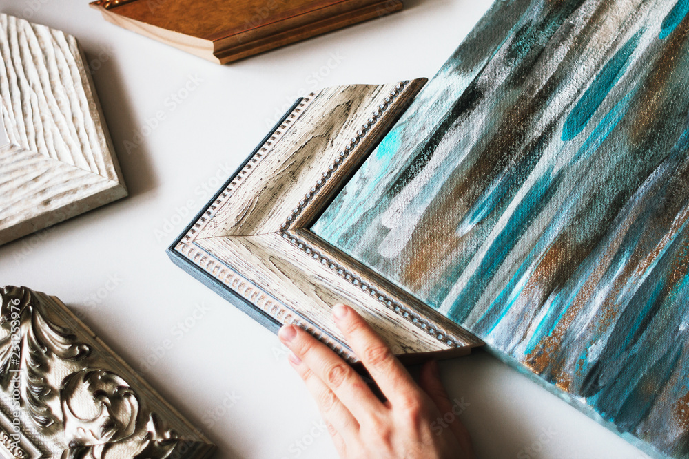 Choosing the frame for a painting. Stock Photo Adobe Stock