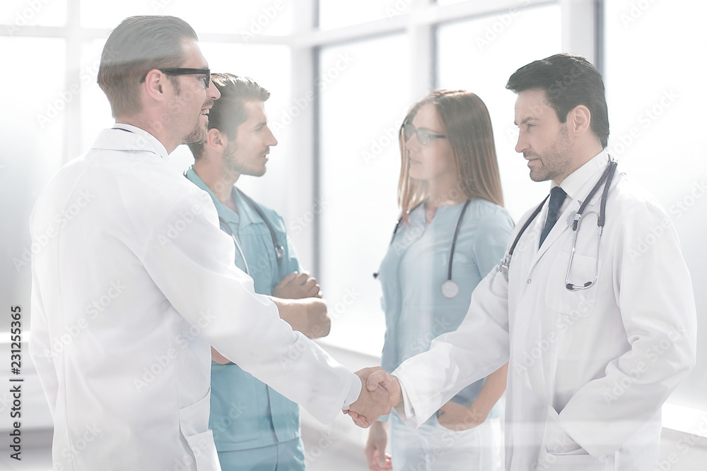 handshake colleagues in the hospital corridor
