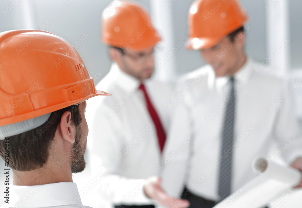 close up. businessman in hard-hat looking at his office close up. businessman in hard-hat looking at his office