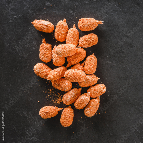 Breaded crab claws on slate stone background. Seafood, top view, flat lay, copy space