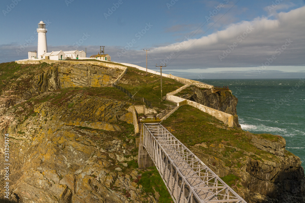 White lighthouse at South Stack with footbridge.