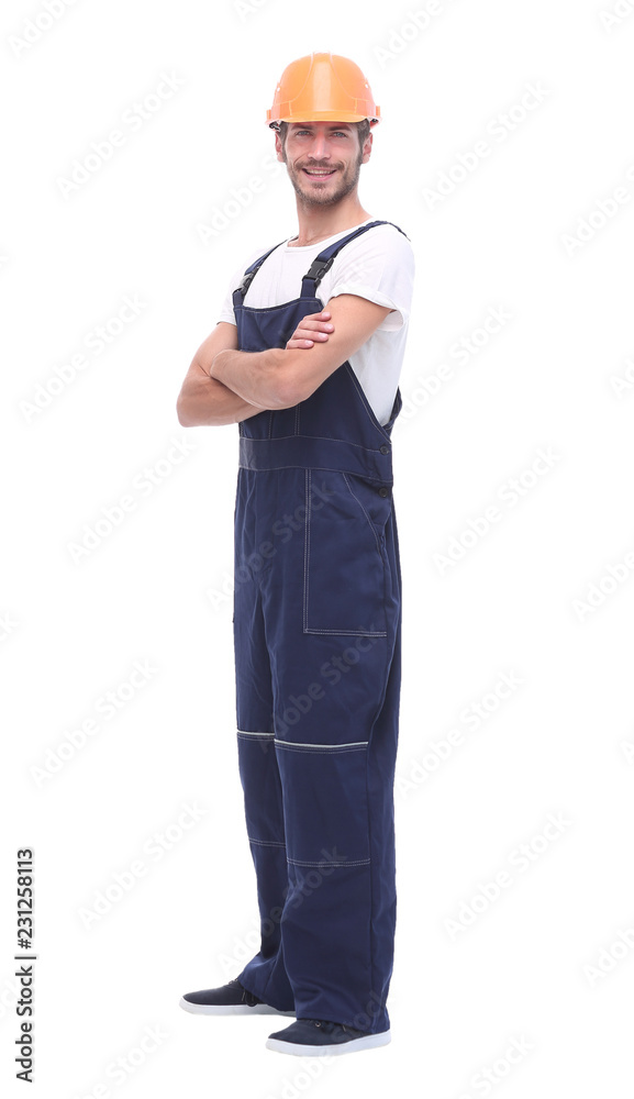 in full growth. confident man wearing overalls and a crash helmet. in full growth. confident man wearing overalls and a crash helmet.