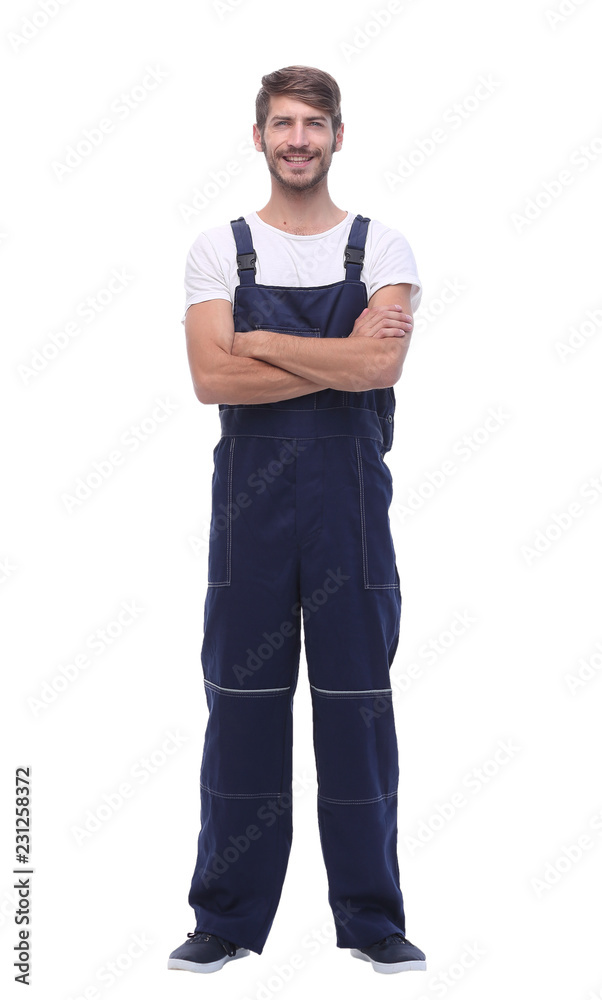 in full growth. smiling man in blue overalls in full growth. smiling man in blue overalls
