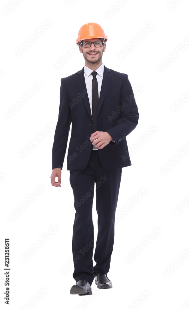 businessman in a protective helmet confidently stepping forward businessman in a protective helmet confidently stepping forward