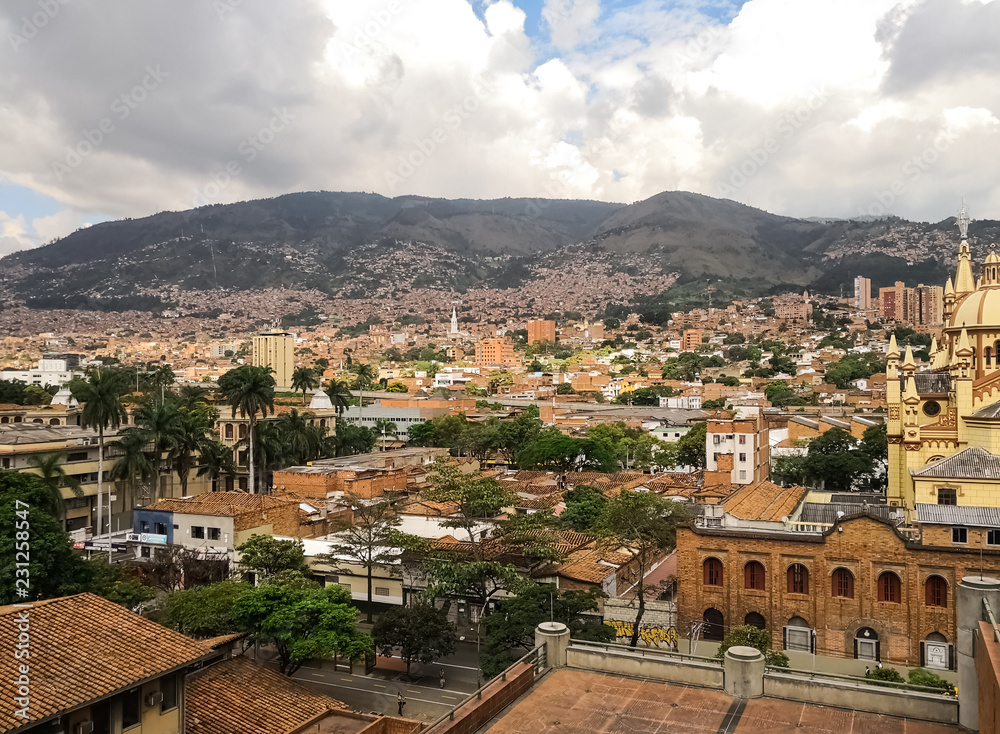 Panoramic view of the traditional and historic neighborhood of Medellin, Colombia, full of orange and terracotta brick buildings and background of the typical mountains