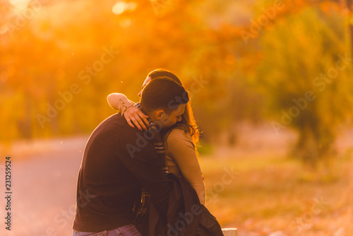 Young couple exchanging emotions before sunset.