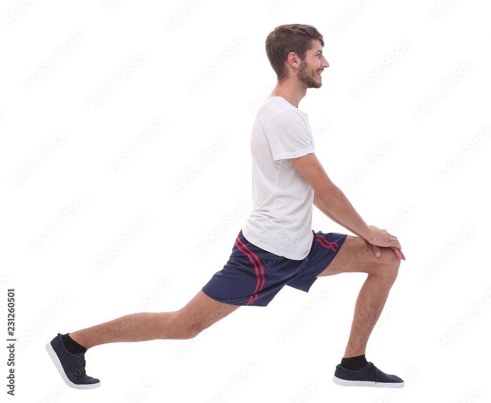 Full length.active male performs squats with straight arms.