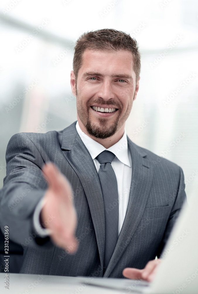 closeup .a successful businessman extends his hand for a handshake,