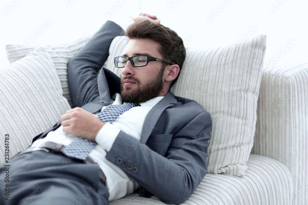 tired businesswoman relaxing on the couch. tired businesswoman relaxing on the couch.