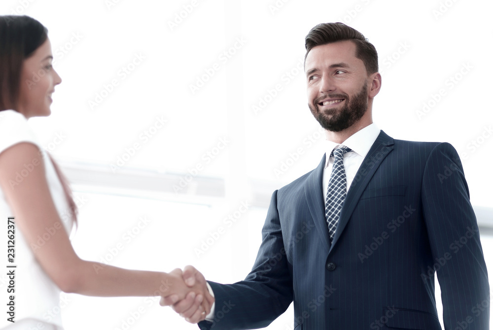 Image of business partners handshaking in office Image of business partners handshaking in office