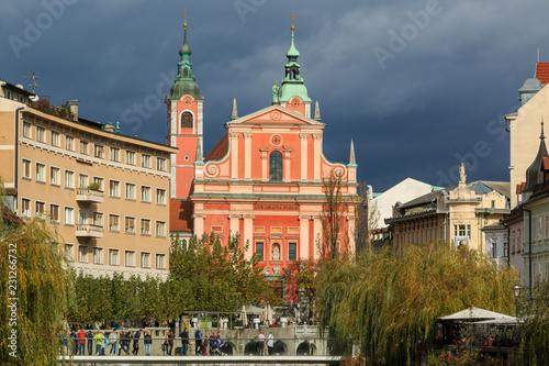 View of Ljubljanica river in old city with dark stormy clouds in the background on an autumn day, Ljubljana, Slovenia © erikzunec