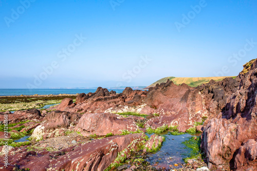Scenic landscape of Pembrokeshire coast  Uk.Beautiful summer morning on rocky beach during low tide.Fantastic weather and clean blue sky above.