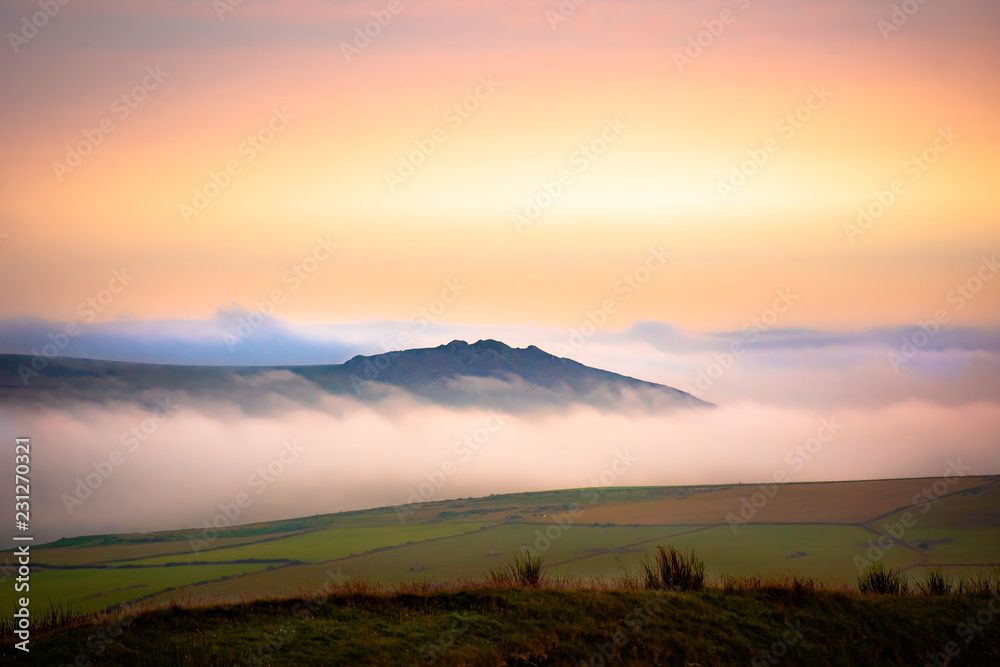 Scenic landscape of Pembrokeshire coast, Uk.Sunrise over misty fields.