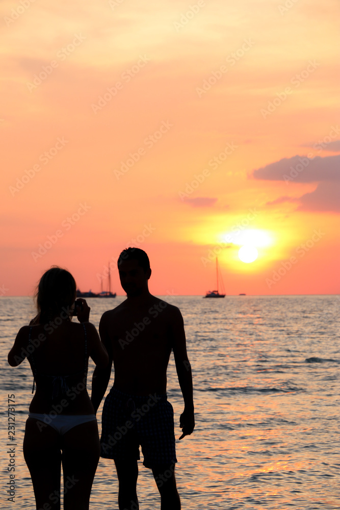 silhouette tourist On the beach Sunset