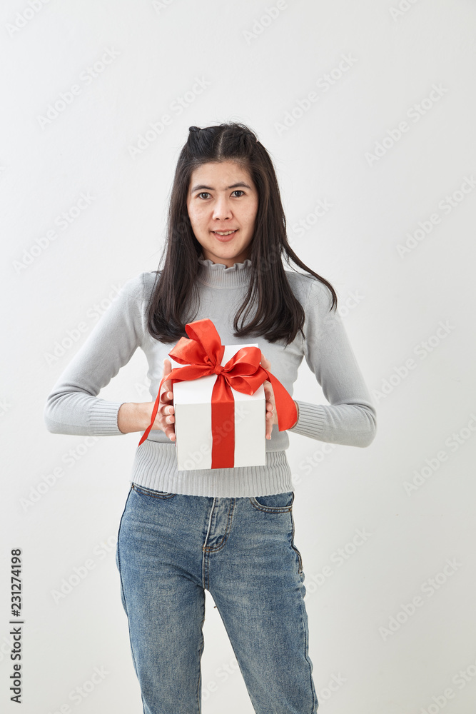 Fototapeta premium Young woman happy hold gift box in hands