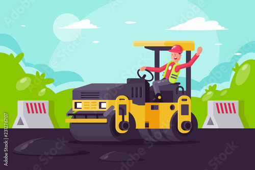 Young man on asphalt paver at work on construction site.