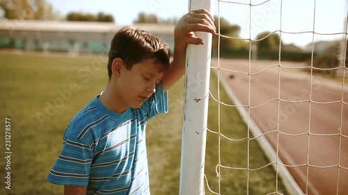 boy teenager soccer football player upset defeat insult sadness and anger. boy teenager grieved after the defeat, well, managed to win. soccer kids concept lifestyle