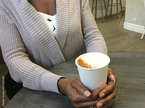 Young African American woman having coffee/tea