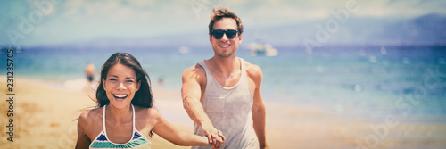 Happy young couple laughing on beach summer lifestyle banner panoramic people lifestyle. Interracial relationship Asian girl, Caucasian man.