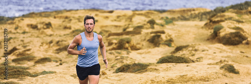 Run fitness exercise training runner man on trail in beach panorama banner header. Male athlete running fast on sand background.