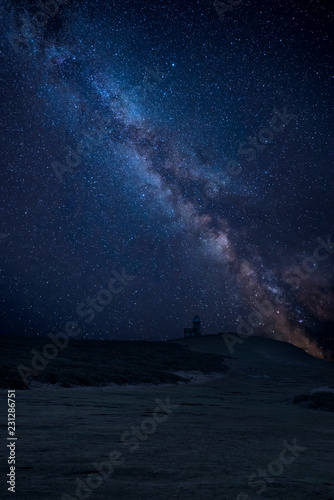 Vibrant Milky Way composite image over landscape of Belle Tout lighthouse on South Downs National Park © veneratio