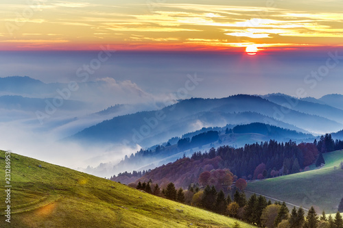 Dramatic sunset over rolling hills of the Black forest in Germany. Scenic travel background.