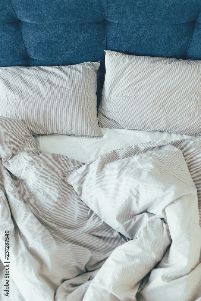 Bed maid-up with clean white pillows and bed sheets in beauty room. Close-up.
