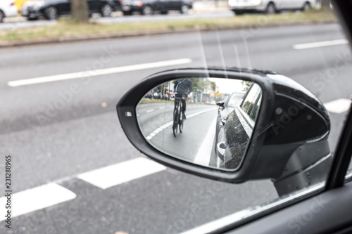 Cyclist in the exterior mirror of a car © David.Sch