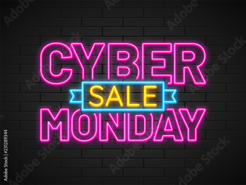 Neon text Cyber Monday Sale in pink and yellow color on brick wall background.